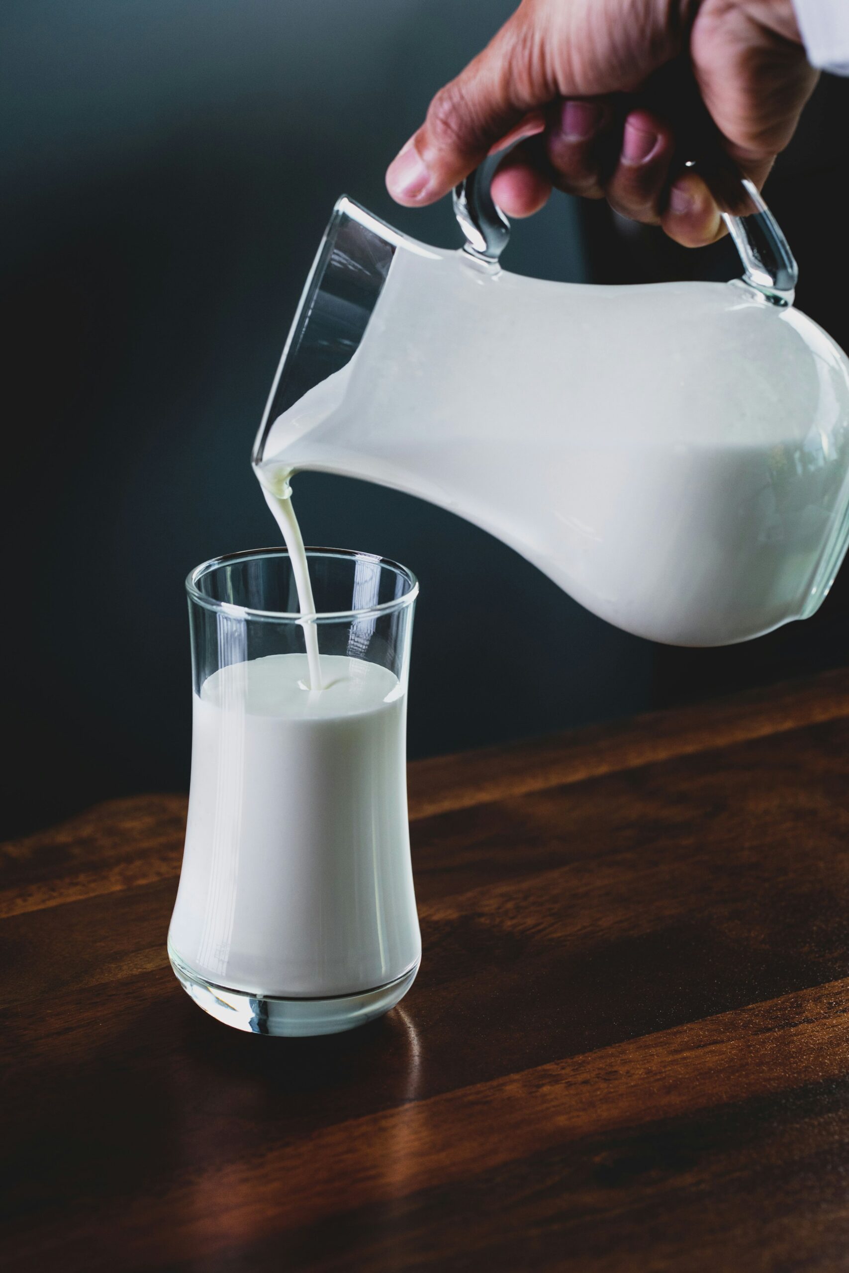 Latte versato in un bicchiere, fonte alimentare di calcio
